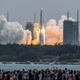 People watch a Long March 5B rocket, carrying China’s Tianhe space station core module, as it lifts off from the Wenchang Space Launch Center in southern China’s Hainan province on April 29, 2021